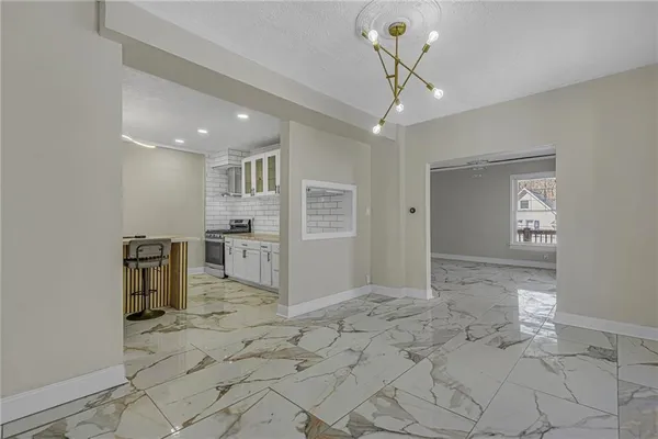 a view of a kitchen with a sink and a refrigerator