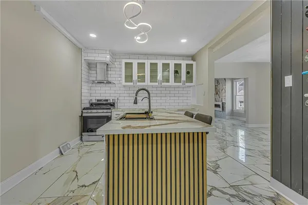 a kitchen that has a stove and a table