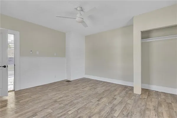 a view of an empty room with wooden floor