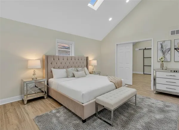 a bedroom with a bed and a couch