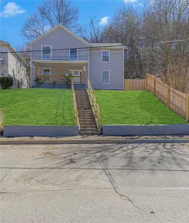 a view of a house with a yard and sitting area