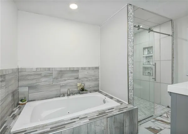 a bathroom with a tub and shower