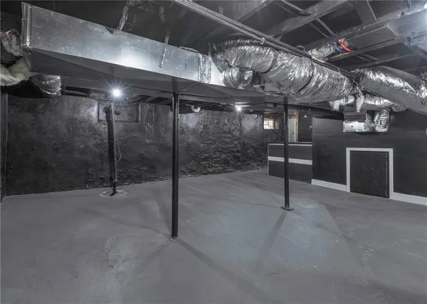 a view of empty room with wooden walls