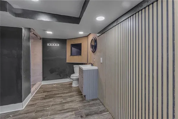 a bathroom with a sink a toilet and mirror