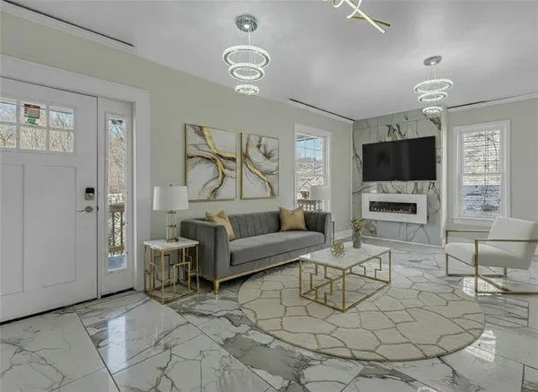 a living room with furniture a large window and a flat screen tv