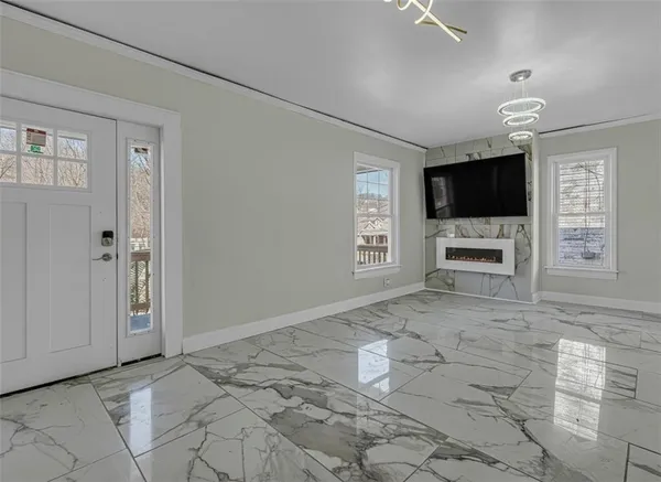 en empty room with windows and flat screen tv