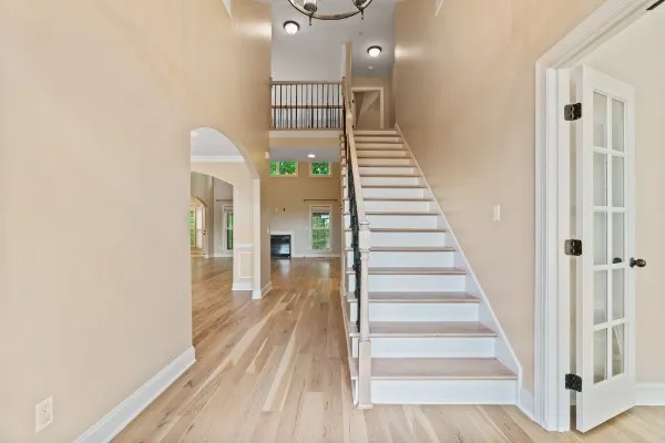 a view of a hallway with wooden floor and entryway