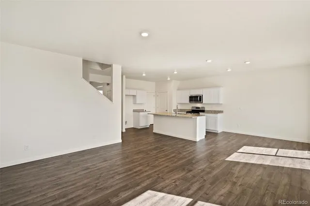 a view of kitchen with wooden floor and electronic appliances