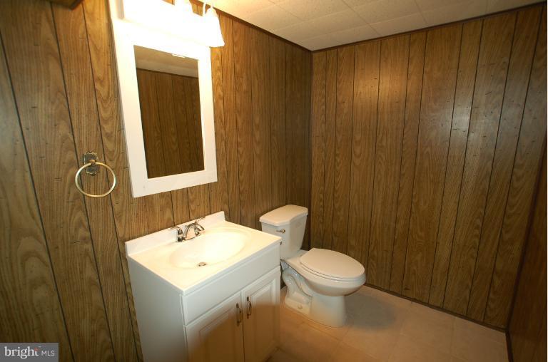 7909 Clark Station Road Severn, MD 21144 - Photo 1 of 11 a bathroom with a sink a toilet and shower