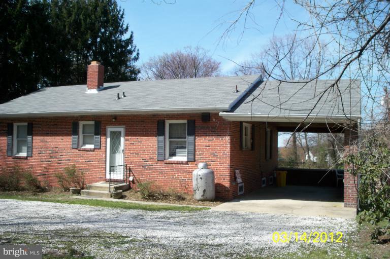 7909 Clark Station Road Severn, MD 21144 - Photo 3 of 11 a front view of a house with garden