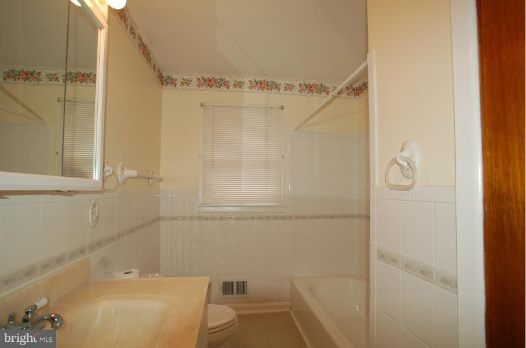 7909 Clark Station Road Severn, MD 21144 - Photo 4 of 11 a bathroom with a bathtub and a shower