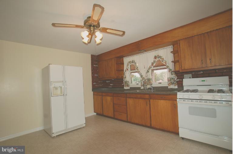 7909 Clark Station Road Severn, MD 21144 - Photo 5 of 11 a kitchen with cabinets appliances and a window