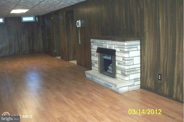 7909 Clark Station Road Severn, MD 21144 - Photo 7 of 11 a view of fireplace with wooden floor