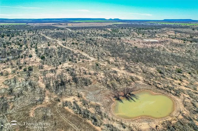 an aerial view of a residential houses with outdoor space
