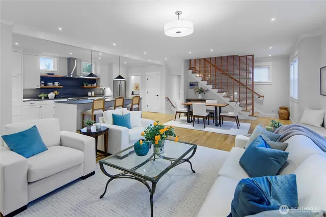 a living room with furniture kitchen view and a couch