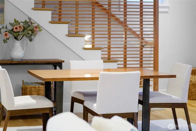 a view of a dining room with furniture and a potted plant