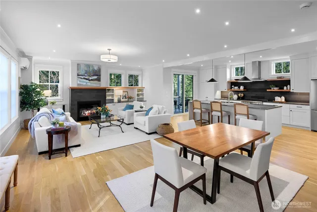 a living room with fireplace furniture and a wooden floor
