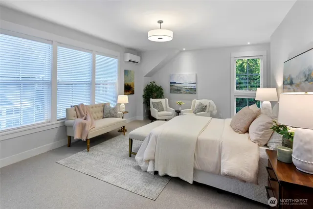 a spacious bedroom with a bed and large windows