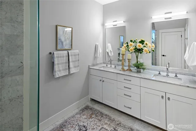 a bathroom with a double vanity sink and a mirror