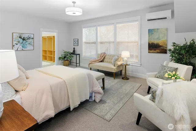 a spacious bedroom with a bed and glass window