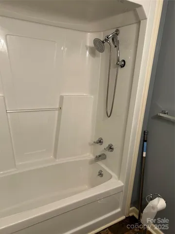 a bathroom with a shower and a bath tub