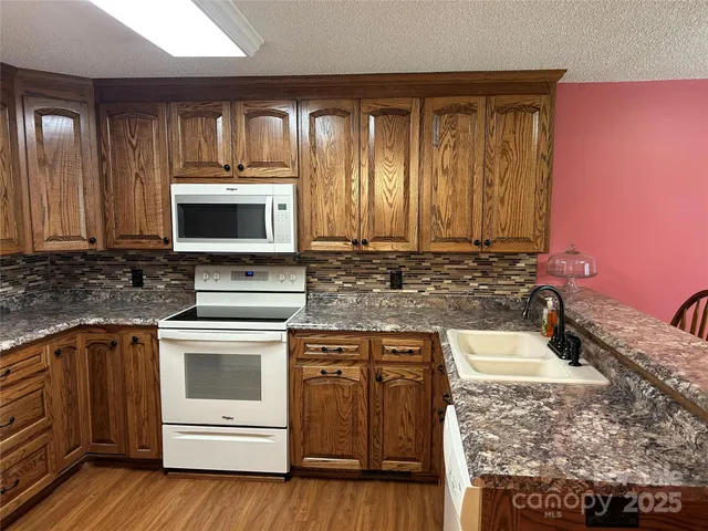 a kitchen with a stove microwave and sink