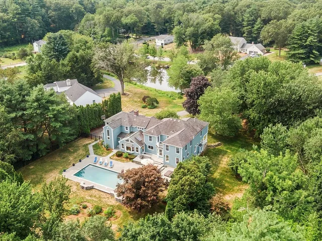 an aerial view of house with yard swimming pool and outdoor seating