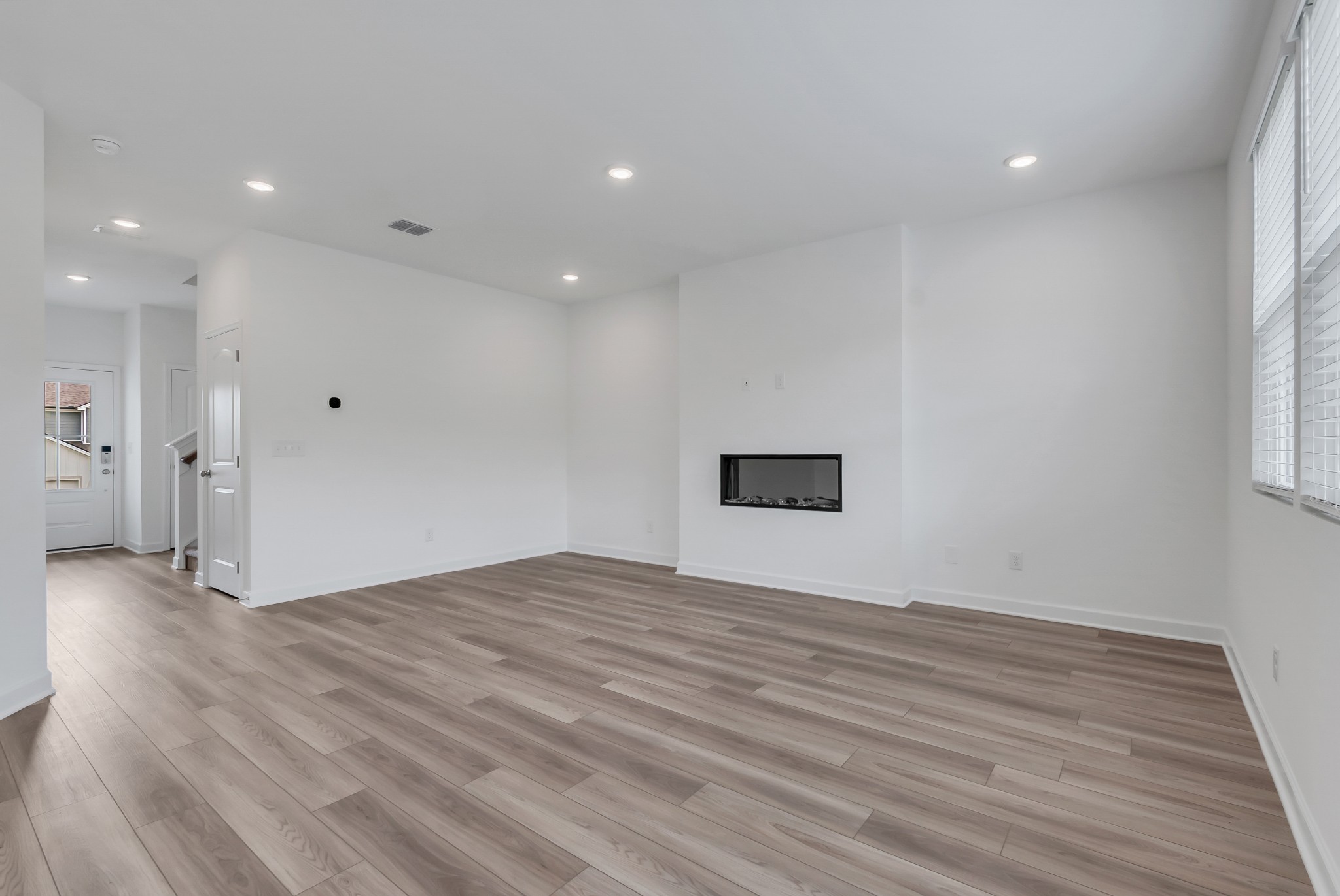 168 Millbrook Drive Spring Hill, TN 37174 - Photo 2 of 13 a view of an empty room with wooden floor and a window