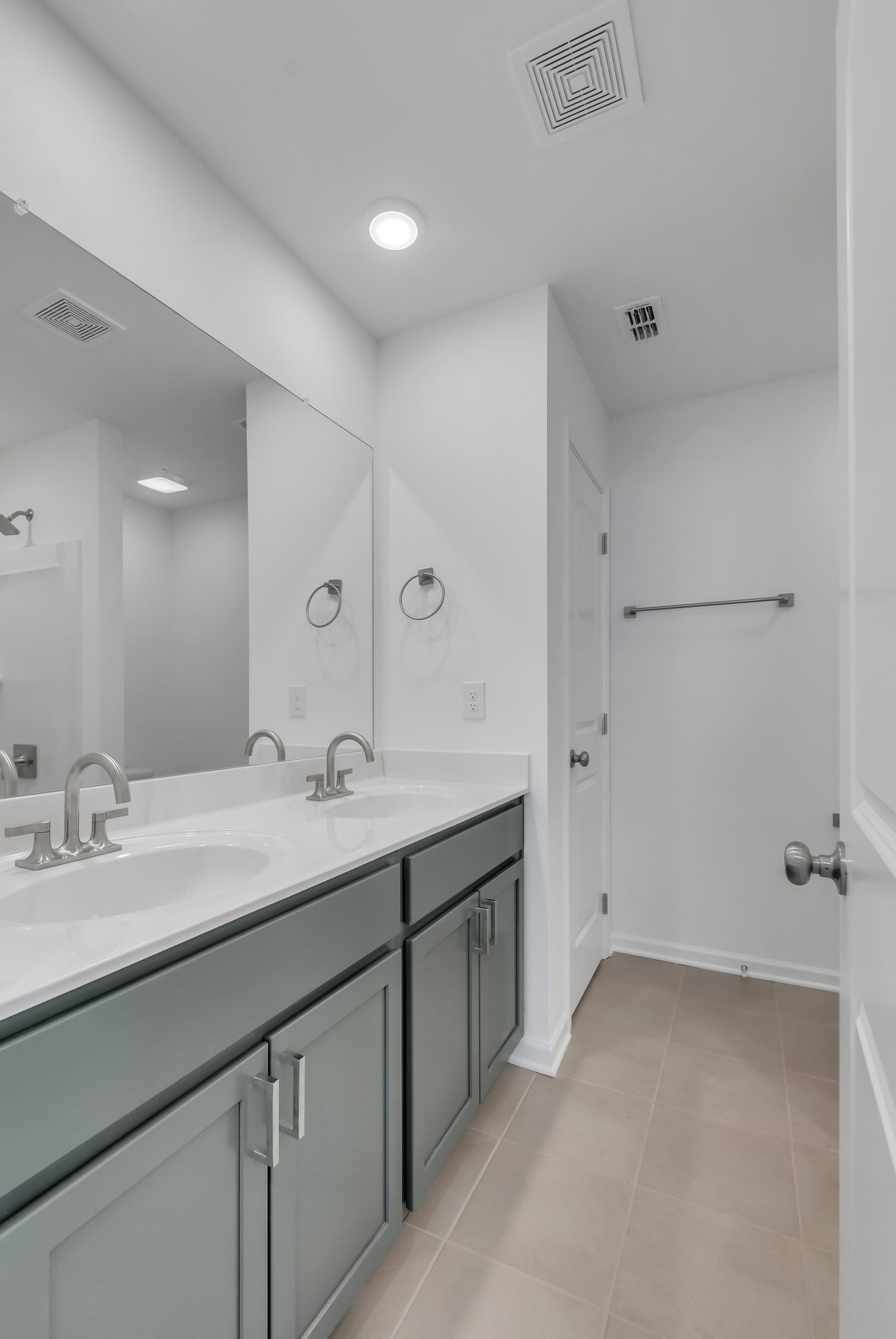 168 Millbrook Drive Spring Hill, TN 37174 - Photo 4 of 13 a bathroom with a double vanity sink and mirror with shower