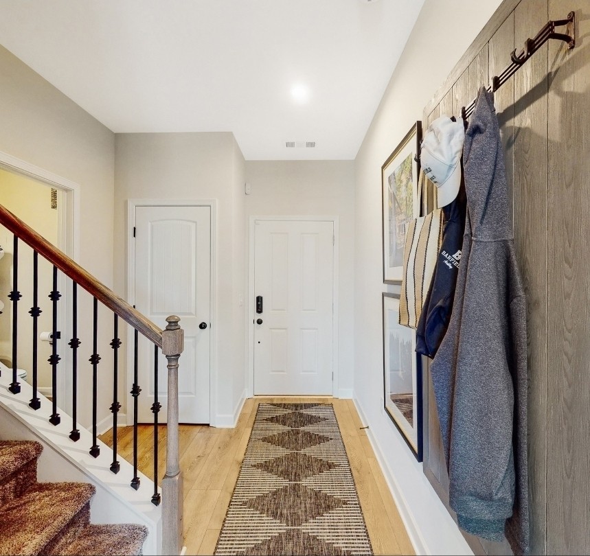 168 Millbrook Drive Spring Hill, TN 37174 - Photo 5 of 13 a view of a hallway with wooden floor and staircase