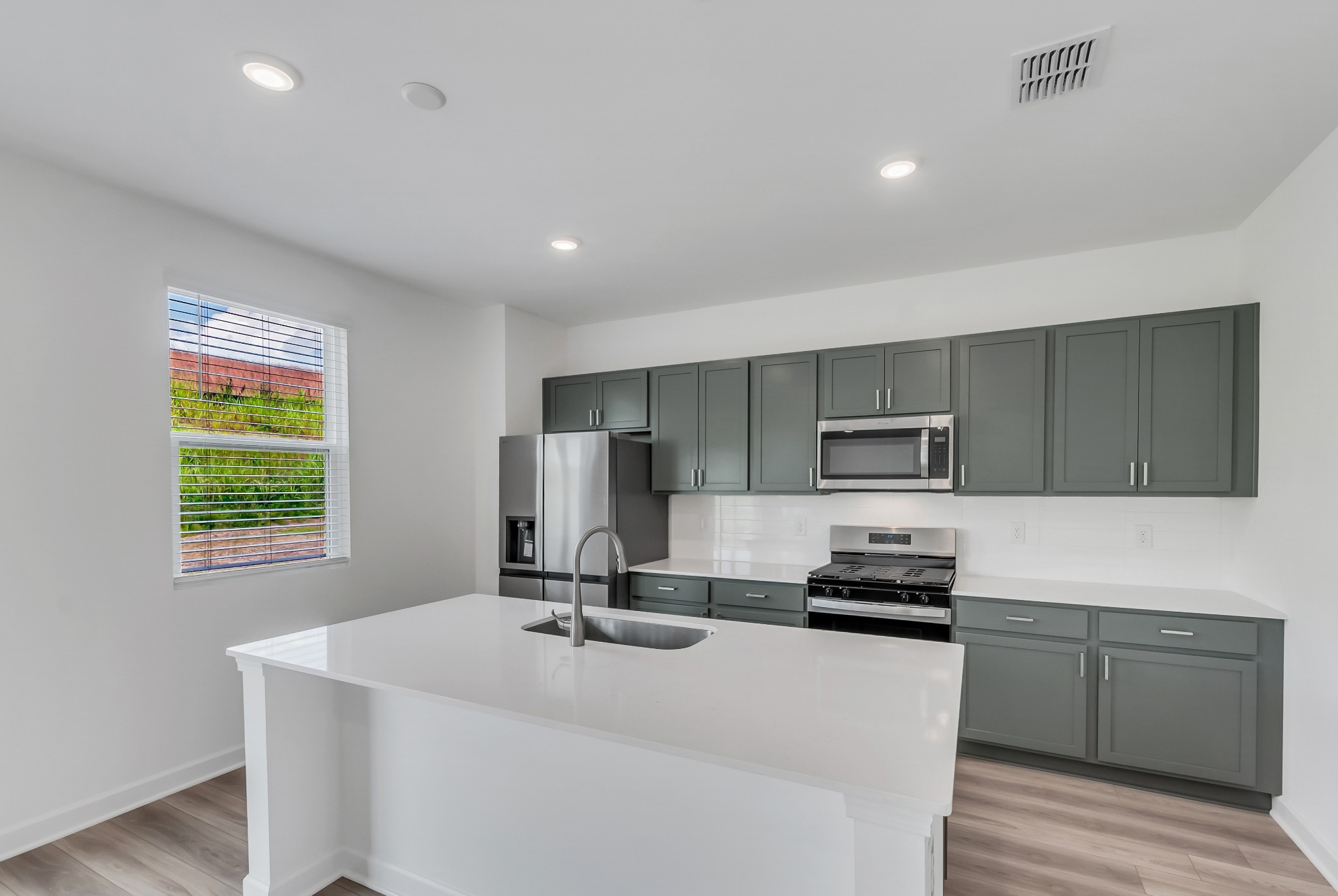 168 Millbrook Drive Spring Hill, TN 37174 - Photo 8 of 13 a kitchen with a refrigerator and a stove top oven