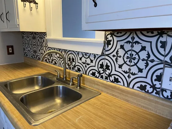 a kitchen with white cabinets and white appliances