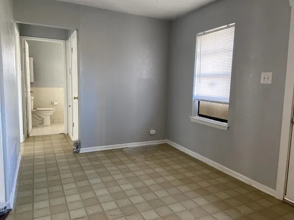 a view of room with hardwood floor and window