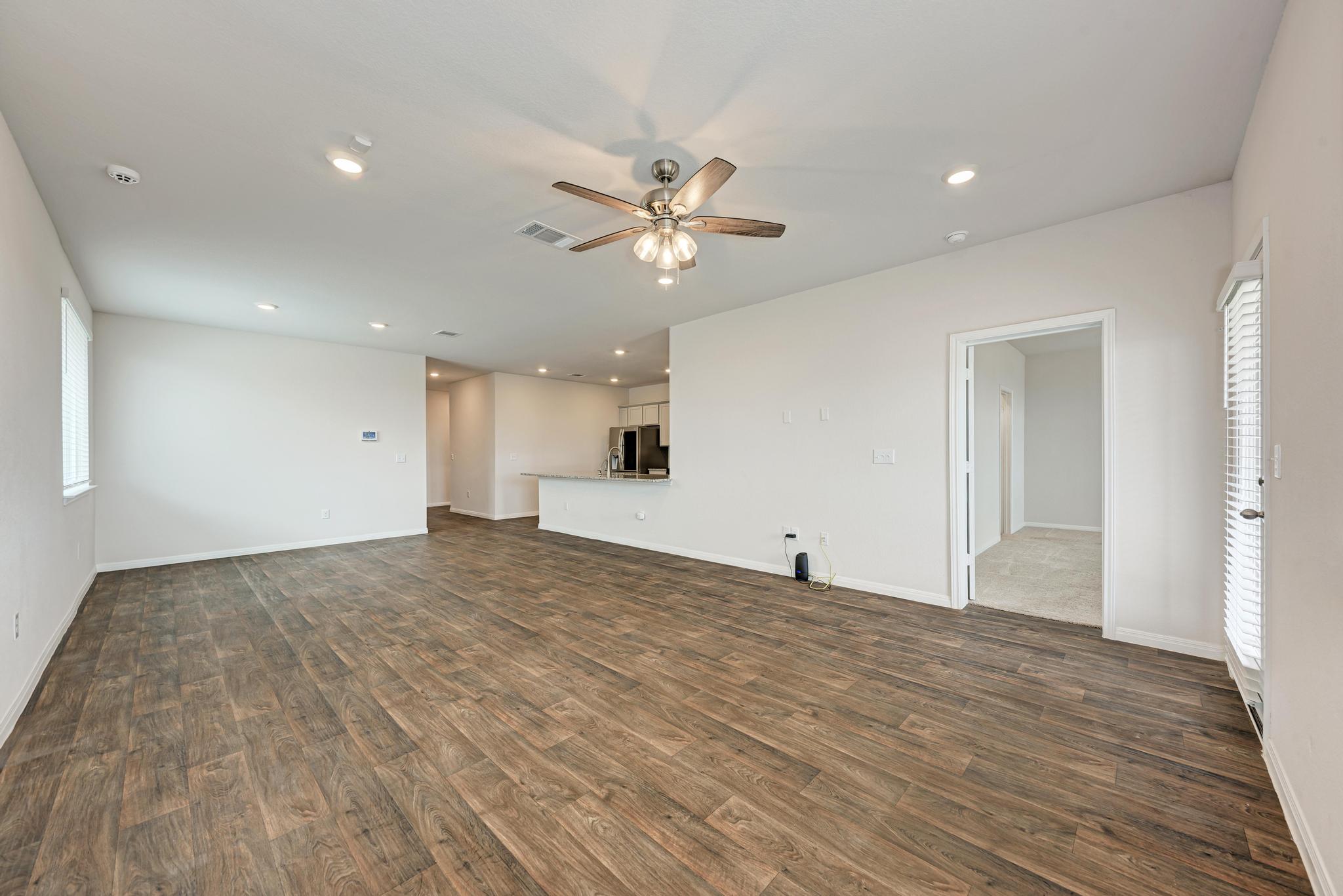208 Abby Road Georgetown, TX 78626 - Photo 22 of 40 a view of empty room with wooden floor and fan