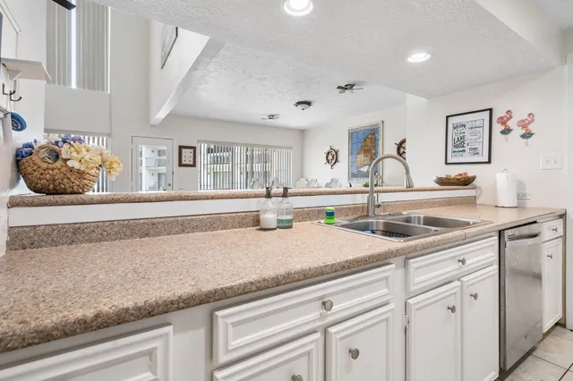 a kitchen with stainless steel appliances granite countertop a sink and cabinets