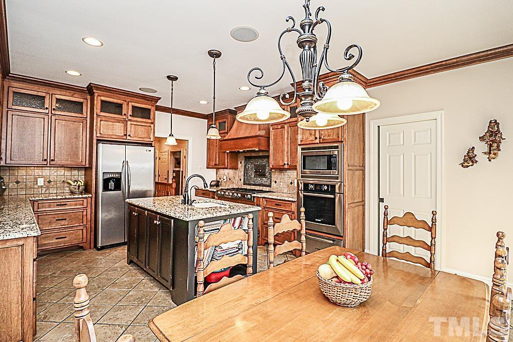 7400 Lancaster Store Road Spring Hope, NC 27882 - Photo 27 of 86 a kitchen with stainless steel appliances granite countertop a stove and cabinets