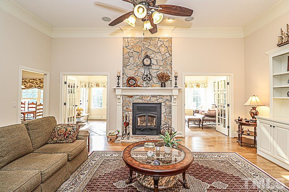 7400 Lancaster Store Road Spring Hope, NC 27882 - Photo 34 of 86 a living room with furniture a fireplace and a table