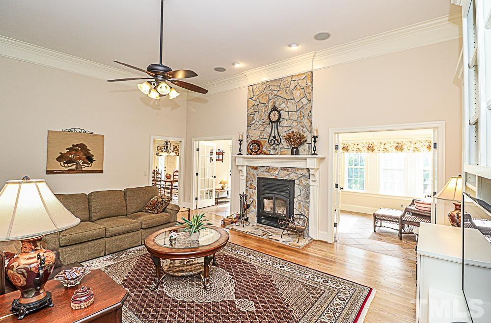 7400 Lancaster Store Road Spring Hope, NC 27882 - Photo 36 of 86 a living room with furniture a fireplace and a table