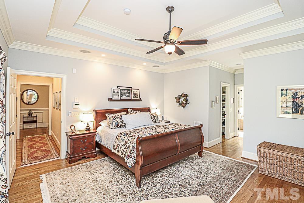 7400 Lancaster Store Road Spring Hope, NC 27882 - Photo 42 of 86 a bedroom with a bed and a chandelier
