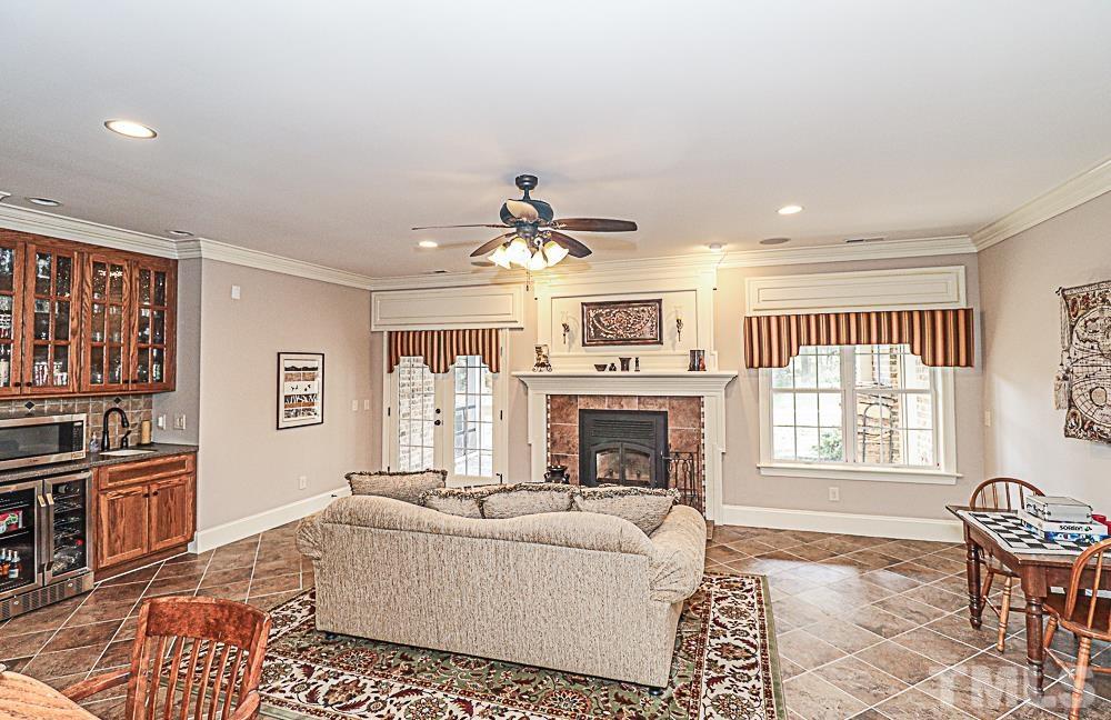 7400 Lancaster Store Road Spring Hope, NC 27882 - Photo 60 of 86 a living room with furniture a flat screen tv and a fireplace