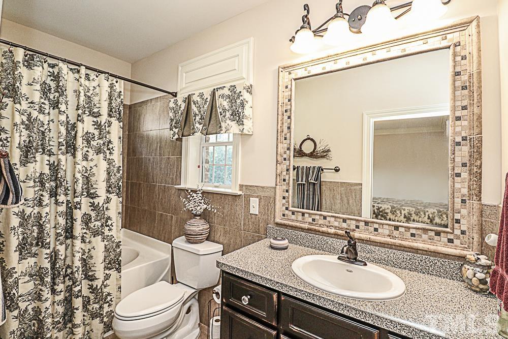 7400 Lancaster Store Road Spring Hope, NC 27882 - Photo 66 of 86 a bathroom with a sink toilet a mirror and shower