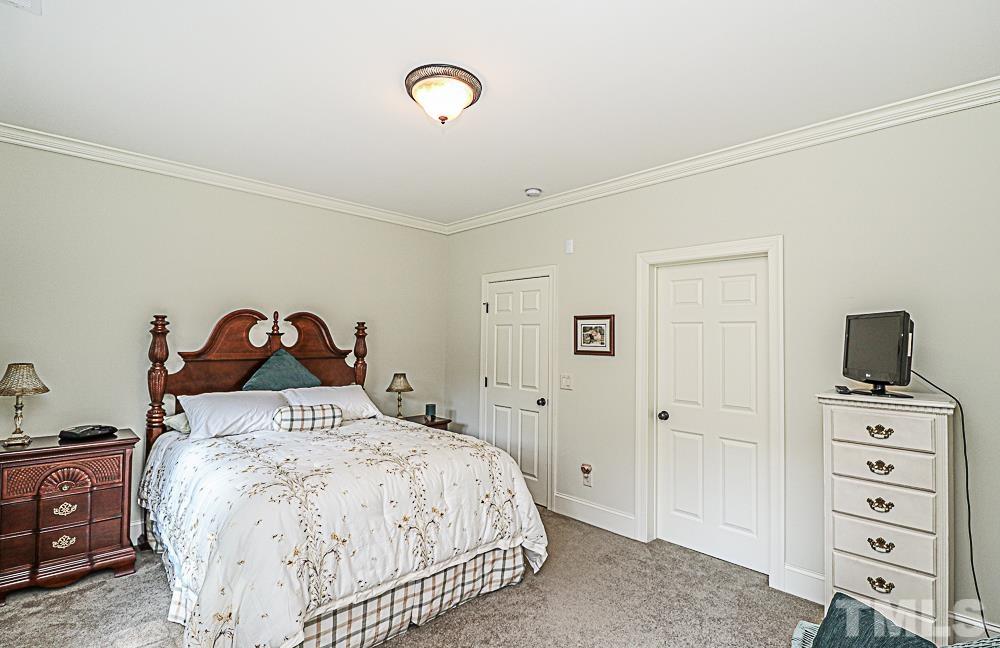 7400 Lancaster Store Road Spring Hope, NC 27882 - Photo 68 of 86 a bedroom with a bed and a tv on the dresser