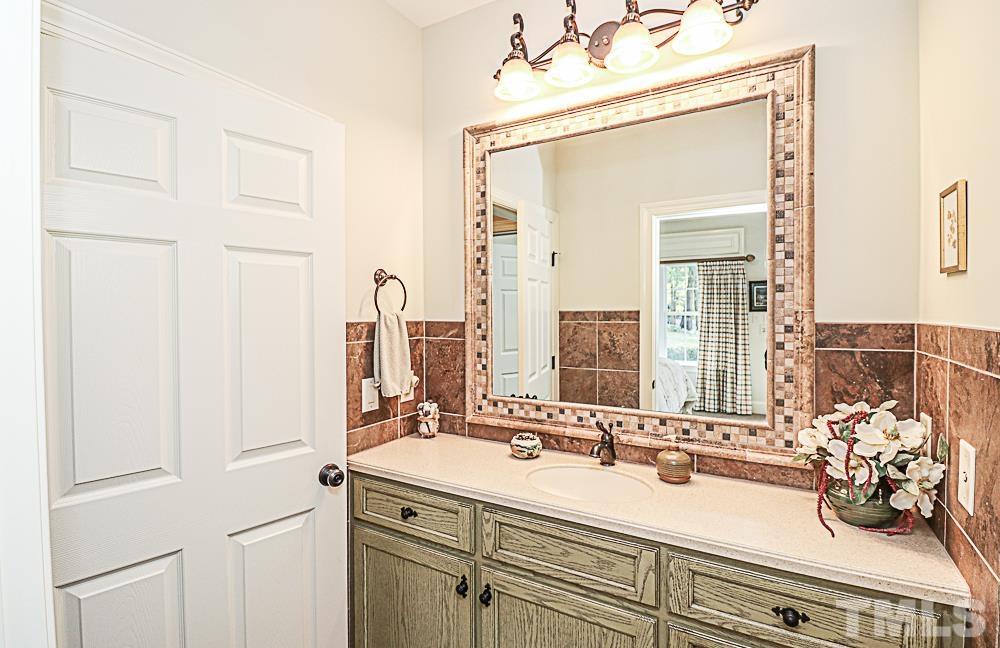 7400 Lancaster Store Road Spring Hope, NC 27882 - Photo 71 of 86 a bathroom with a double vanity sink and a mirror