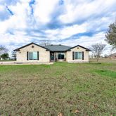 a view of house with backyard