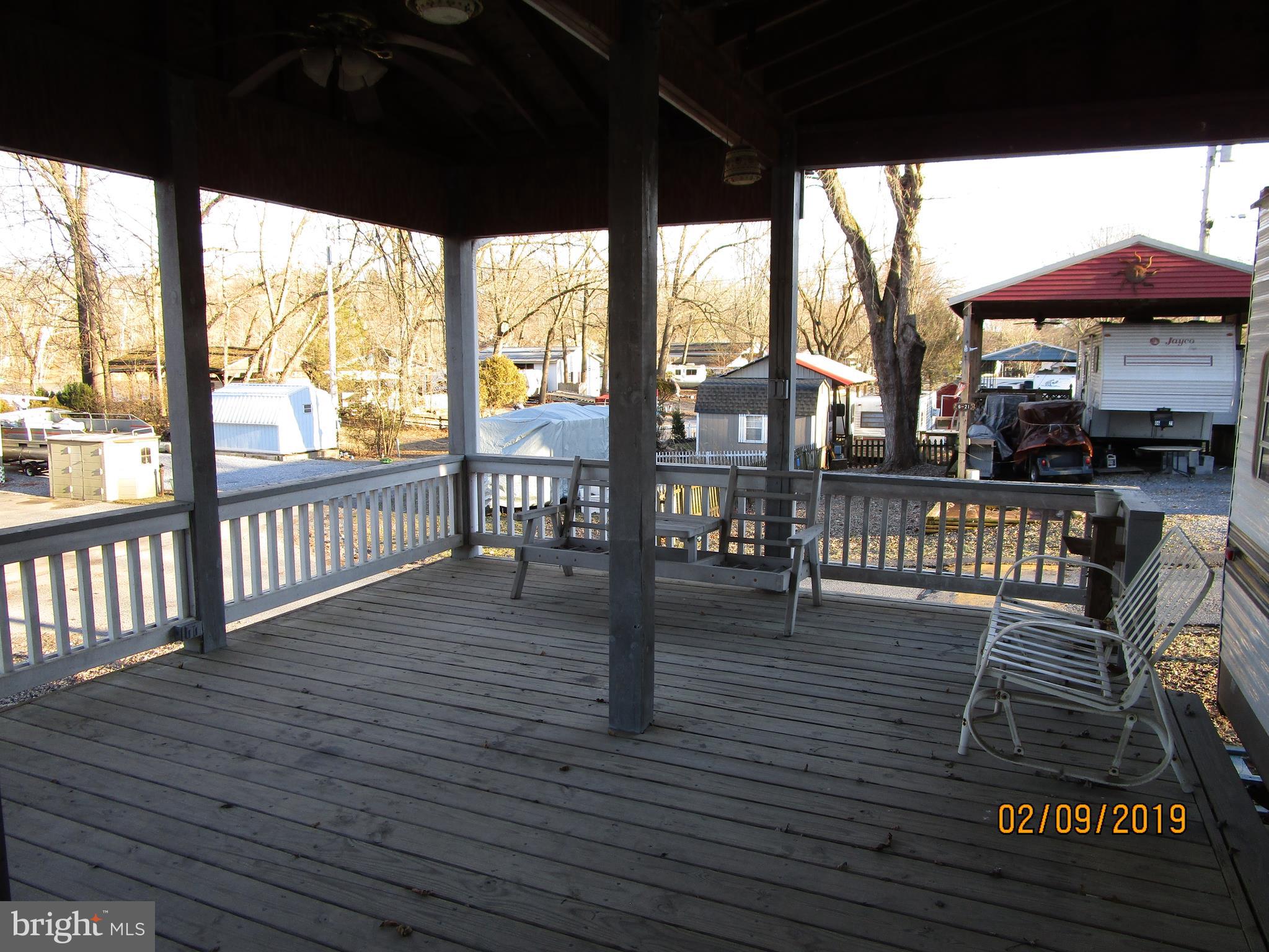 220 Boo Boo Boulevard Falling Waters, WV 25419 - Photo 8 of 14 Deck in front of travel trailer