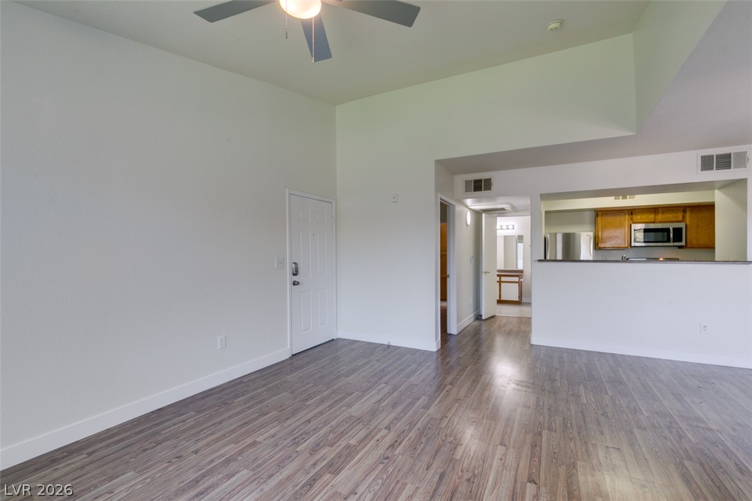 6650 West Warm Springs Road, Unit 2118 Las Vegas, NV 89118 - Photo 28 of 41 An inviting open-concept living area with soaring ceilings and durable wood-look flooring.