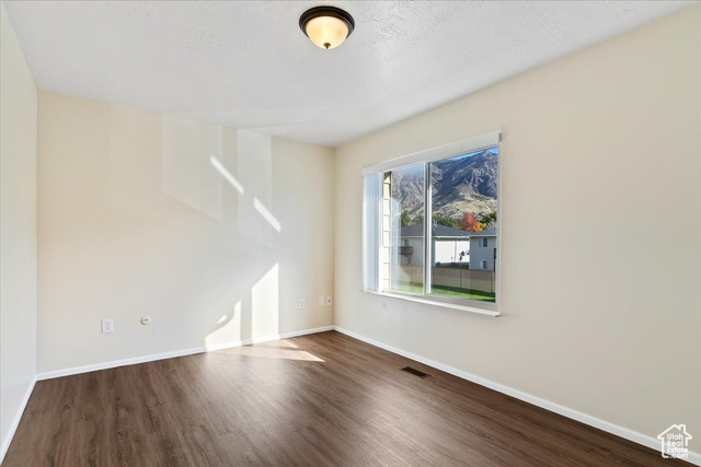947 Canyon Road South, Unit 15 Ogden, UT 84404 - Photo 17 of 22 Empty room with baseboards and dark wood-style flooring