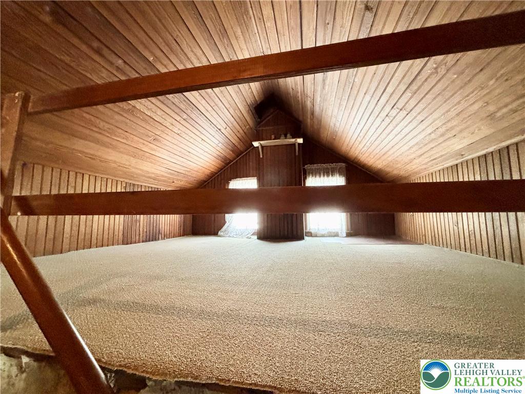 7241 Decatur Street New Tripoli, PA 18066 - Photo 27 of 36 Discover potential in this unfinished attic space, offering natural light and exposed wood beams.