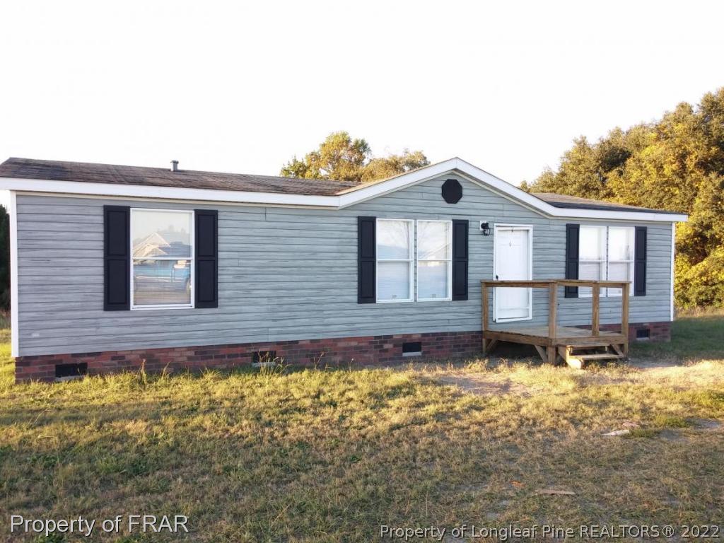 358 Capel Mill Road Candor, NC 27229 - Photo 1 of 11 a front view of a house with a yard