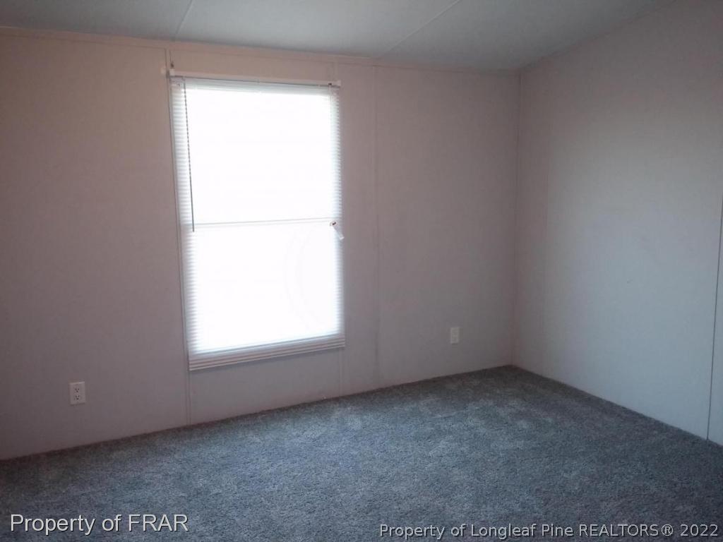 358 Capel Mill Road Candor, NC 27229 - Photo 8 of 11 an empty room with a window